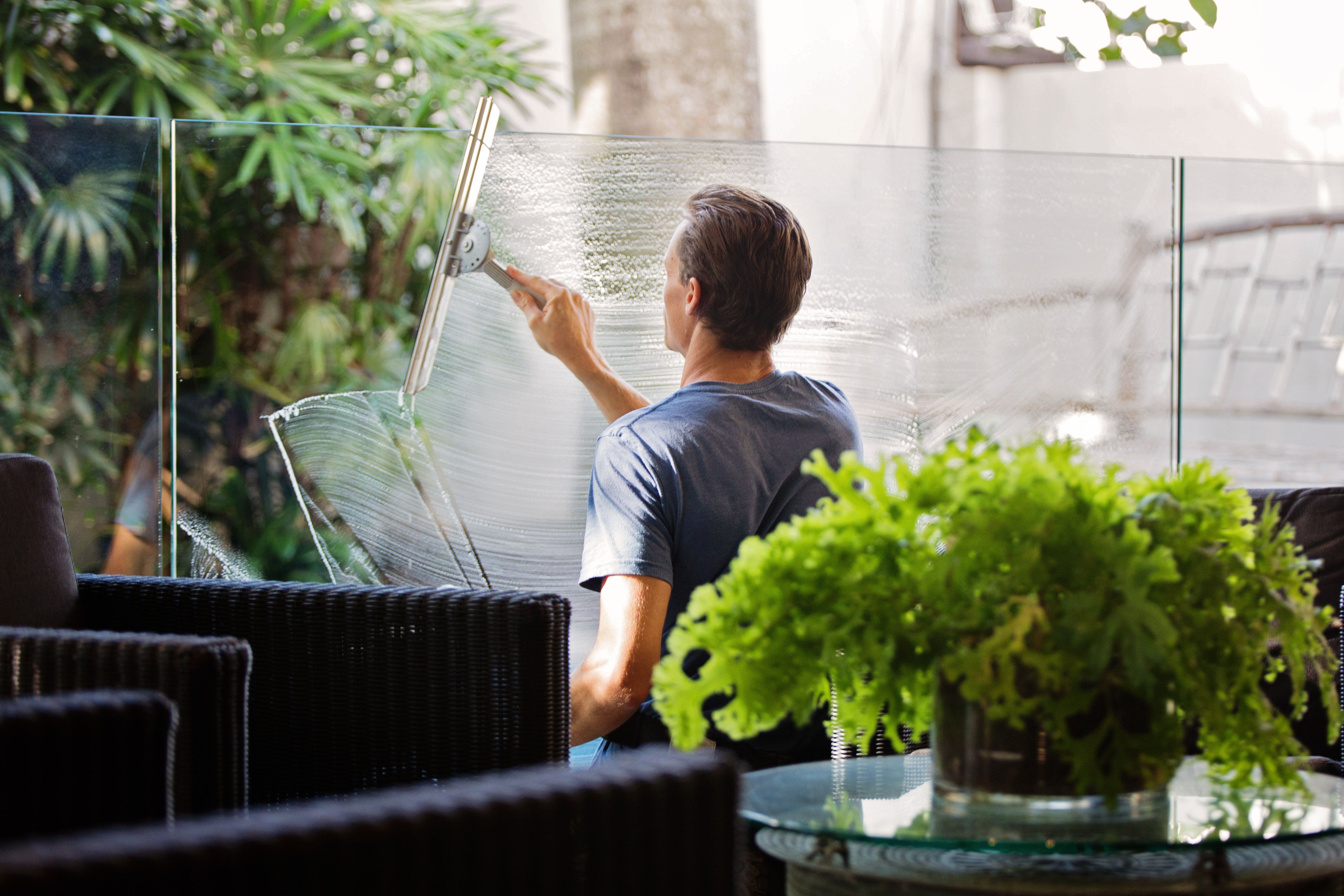man cleaning glass windows glass countertop maintenance